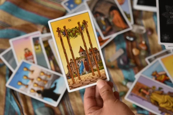 Intuition & Tarot: Trusting your inner voice - 8 A hand holding a tarot card among scattered tarot cards and crystals, ideal for divination or meditation.