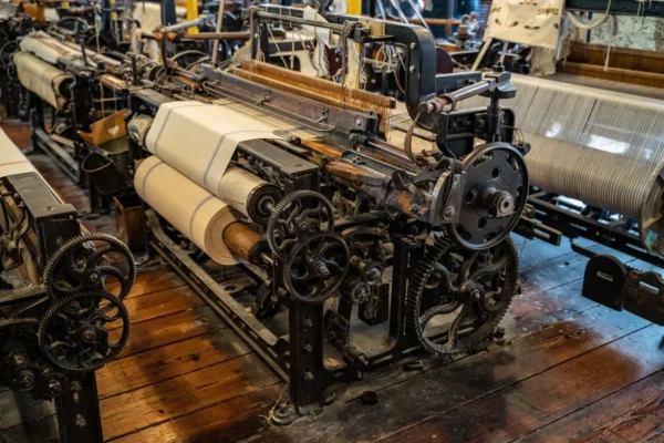 Tarot and AI: My Case For and Against AI - 8 Explore the intricate mechanics of a vintage textile loom in a historic Polish factory setting.